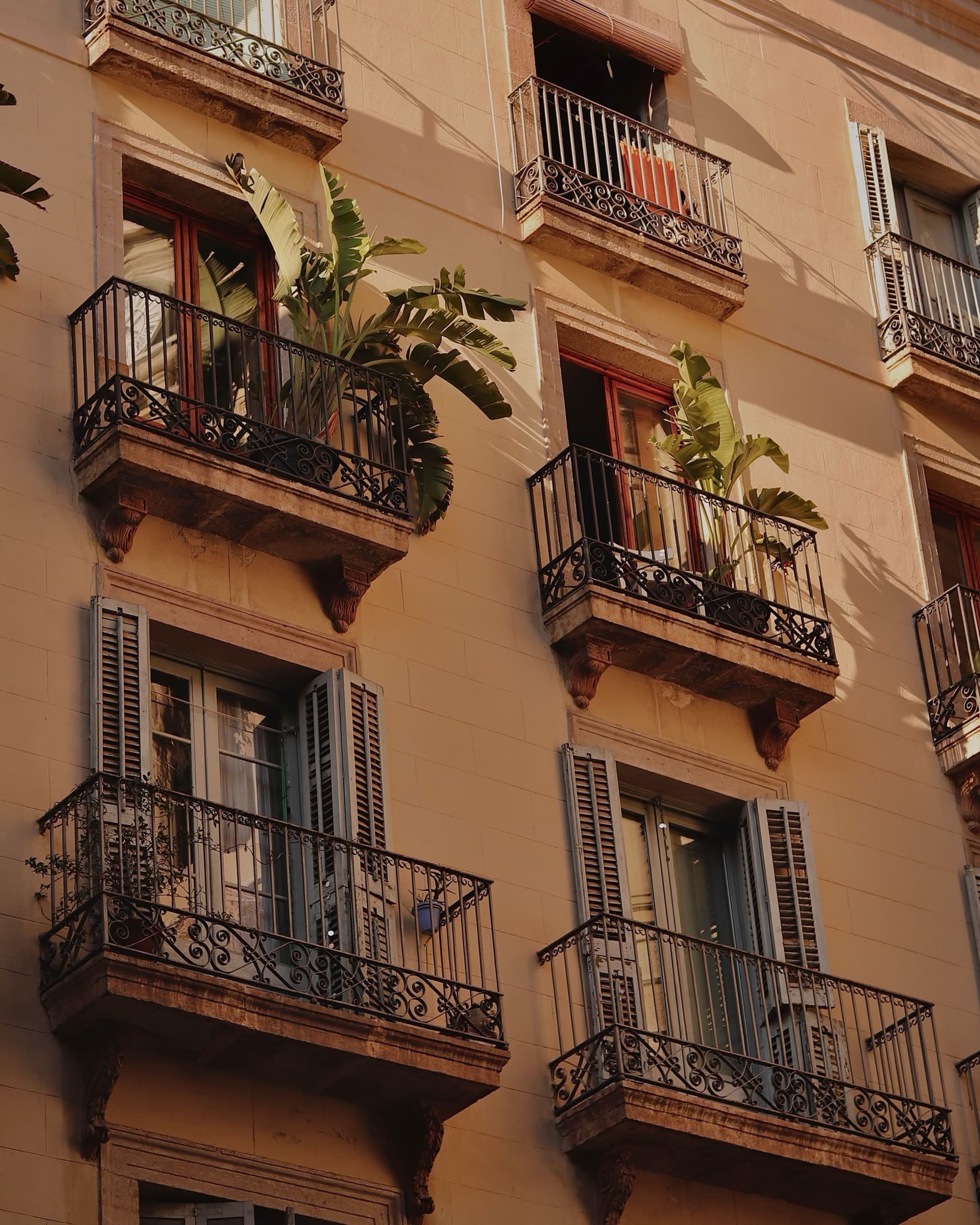 A Barcelona facade of wrought-iron balconies in warm morning light